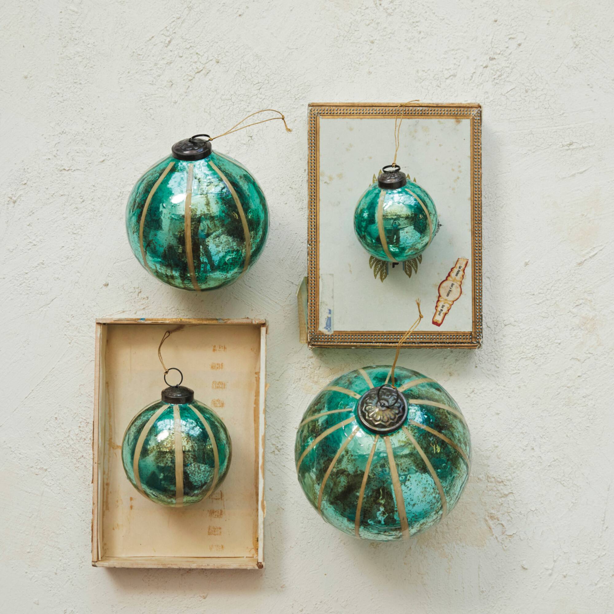 Hello Honey® 12 Pack 4" Turquoise Glass Ball Ornament with Eucalyptus Leaves